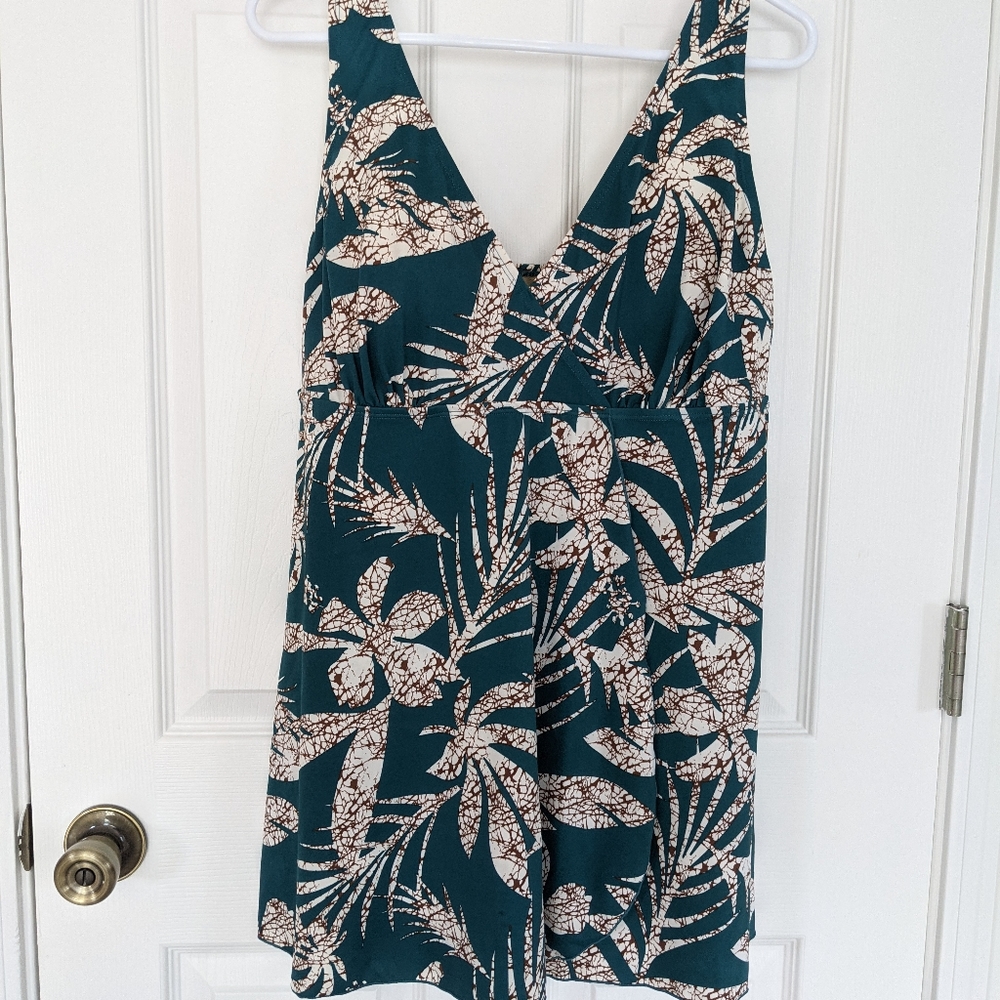 One piece bathing suit with tropical leaf design.